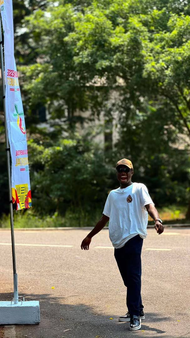 Beside a West Africa Youth Days banner
