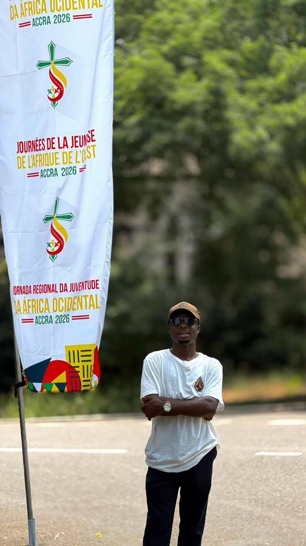 Beside a West Africa Youth Days banner