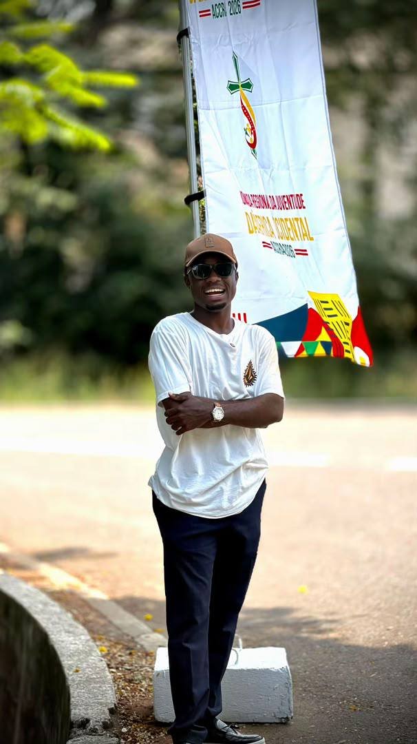Beside a West Africa Youth Days banner